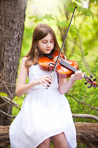 istock Beautiful Girl Playing Viola In Forest 495873411
