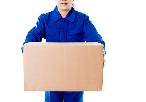 Delivery woman holding cardboard box against white background.