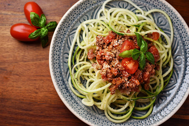 Zoodles with vegan bolognese and yeast flakes stock photo