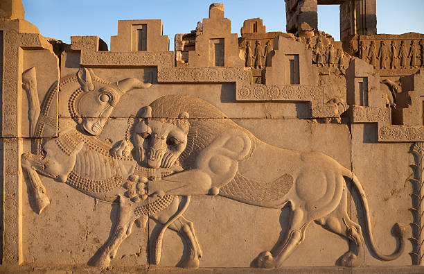 Bas Relief Carving of Lion Hunting a Bull in Persepolis stock photo