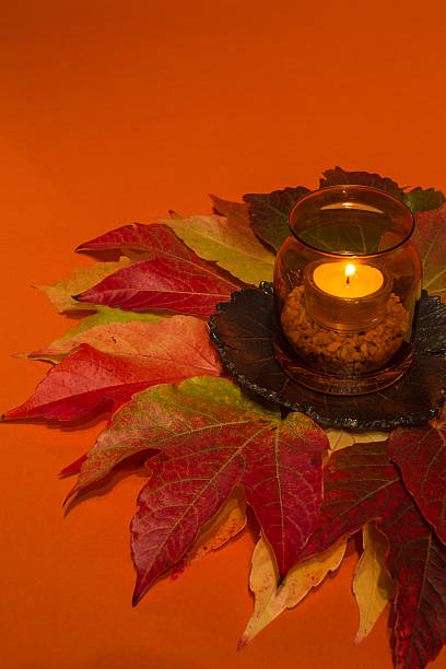 istock candle  on autumn leaves 495881910