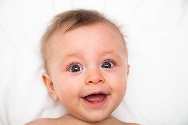 istock Happy blue eyed baby on white 495882844