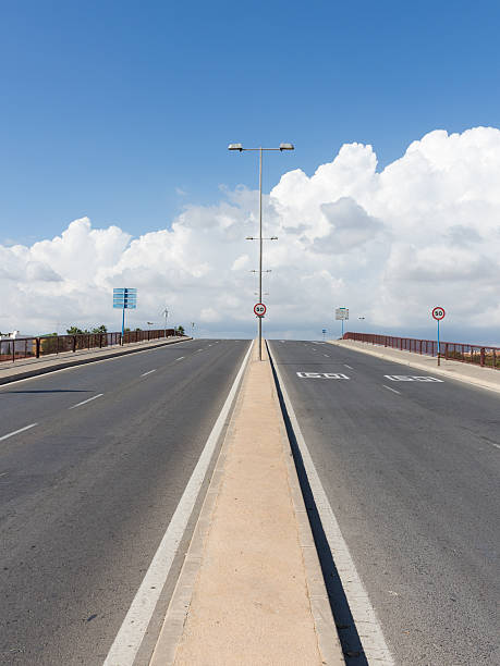 istock gray asphalt road goes into the distance 495883882