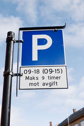 Norwegian parking sign with additional plate with parking rules. Parking fee 9-18 working days and 9-15 on Saturdays.