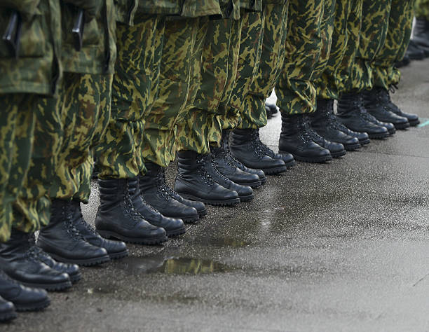 istock Soldiers in camouflage military uniform on rest position 495899436