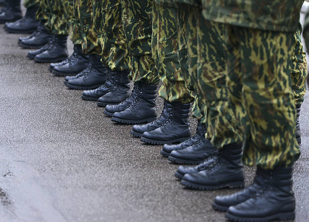 istock Soldiers in camouflage military uniform on rest position 495899564