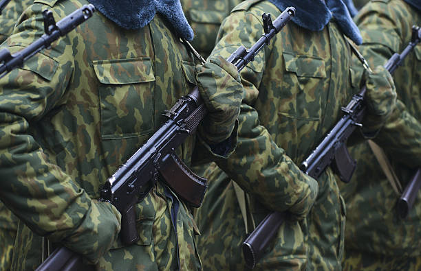 istock Soldiers in camouflage military uniform on rest position 495899596