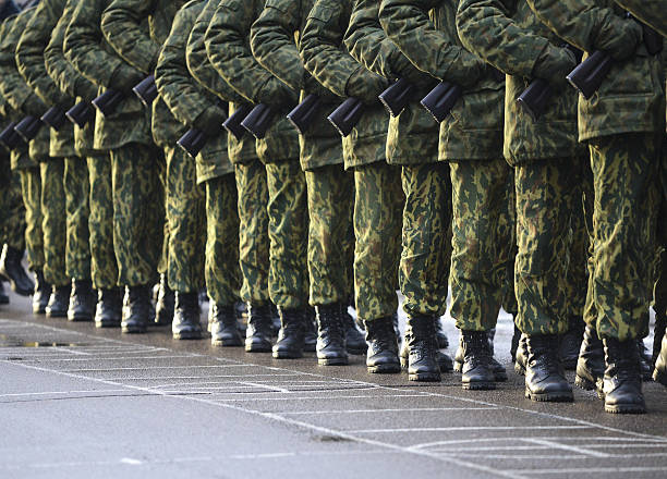 istock Soldiers in camouflage military uniform on rest position 495899620