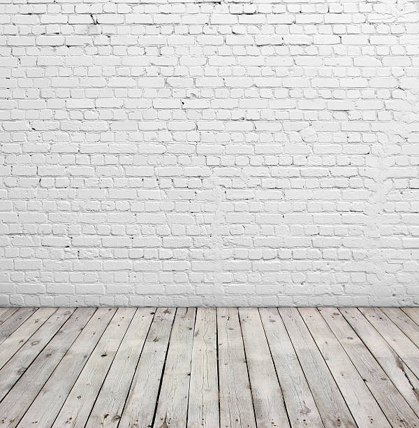 istock White brick wall and wood floor. 495900254