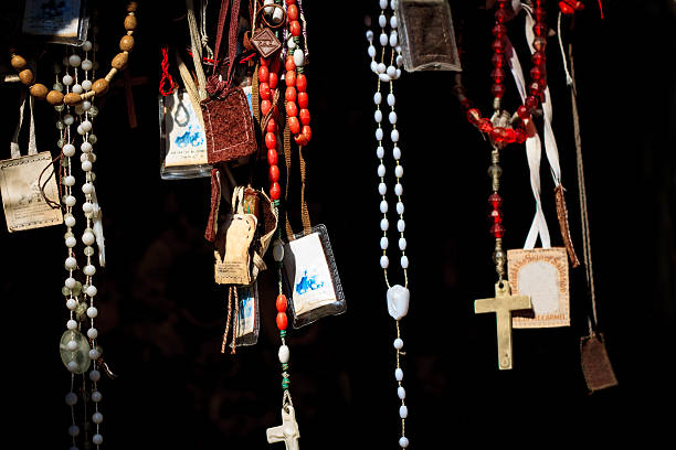 istock Bright Rosary Beads, Crucifixes, Amulets Hang Against Black Background 495900474