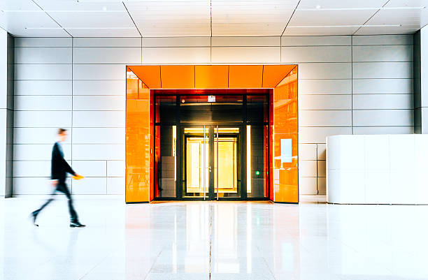 istock Blurred businessmen walking inside a modern building 495902988