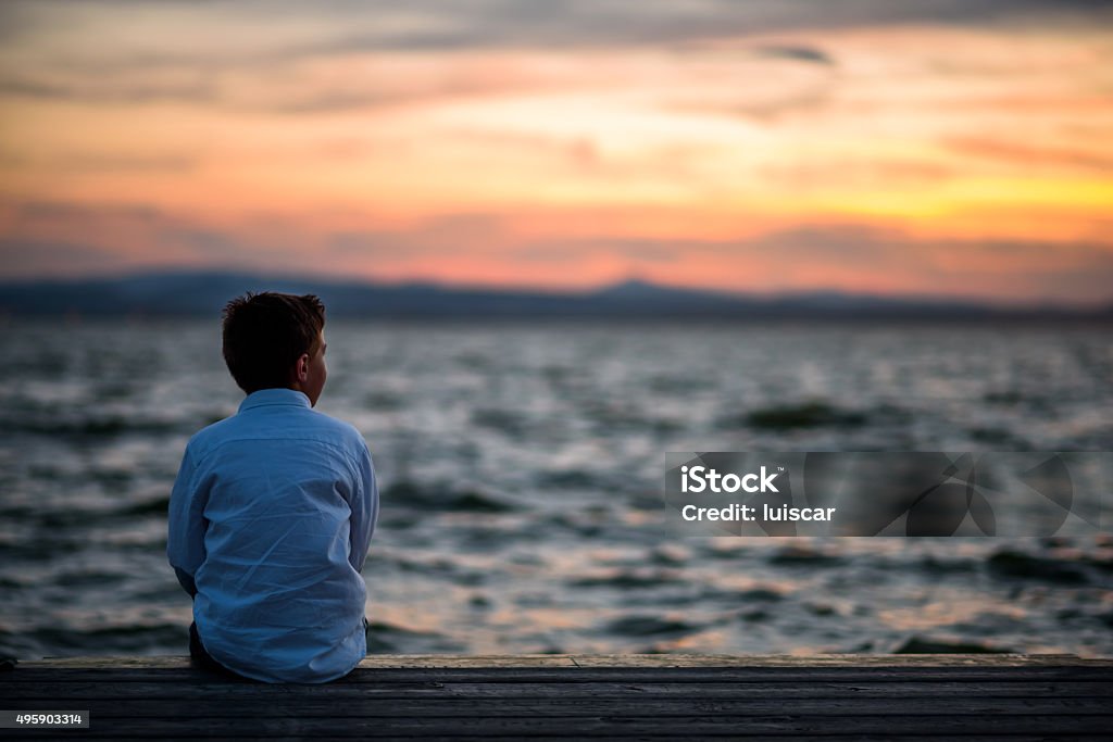boy posing in the lagoon child posing in the lagoon at sunset Valencia 2015 Stock Photo