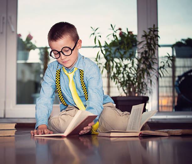 istock Little boy with books at home 495907602