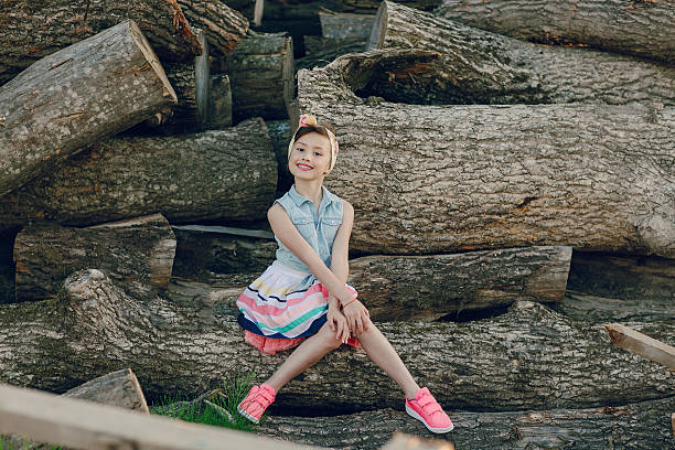 istock beautiful little girl sitting on trees 495910130