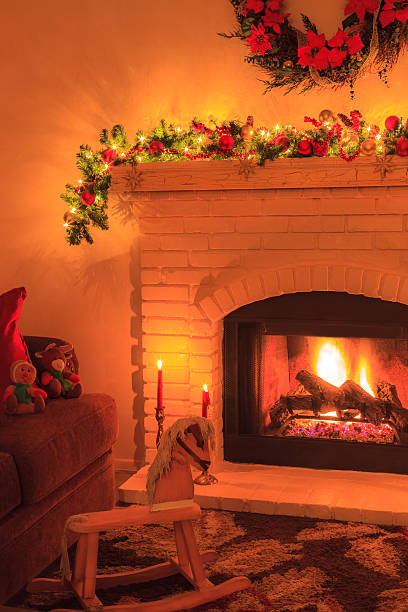 istock Christmas brick fireplace with fire, rocking horse,candles (P) 495911794