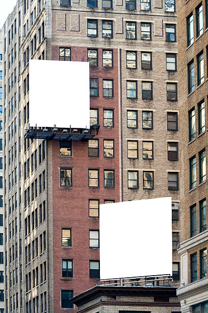 Two big white blank billboards on the brick building. stock photo
