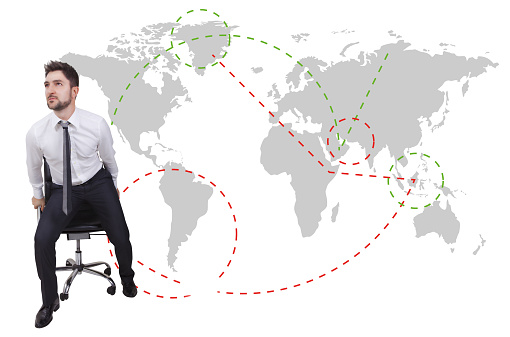 businessman traveler with chair on a map background