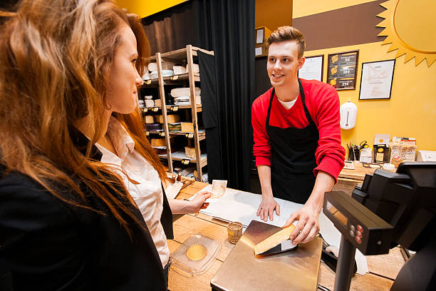 istock Female customer buying cheese at store 495917359
