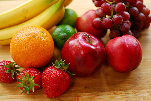 istock mixed fruits on a wooden surface in the sun 495917807