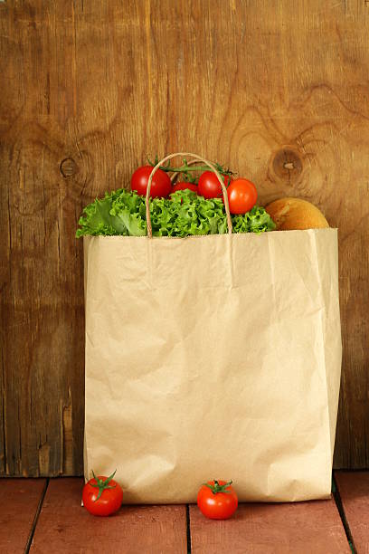 istock paper bag with food, lettuce, tomatoes, bread 495918285