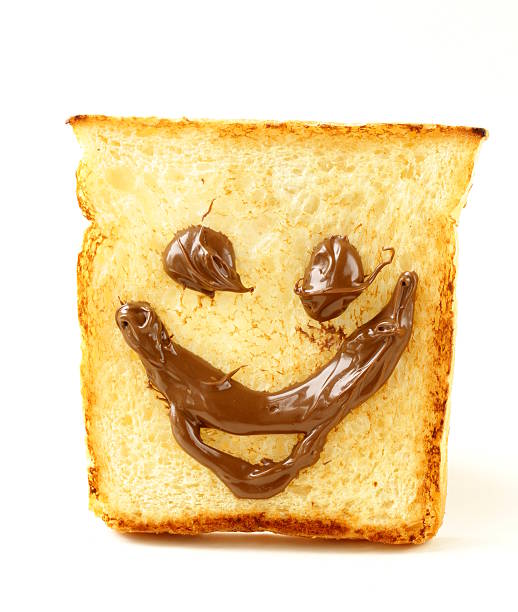 istock funny toast bread with chocolate smile on white background 495919903