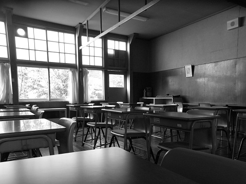 An old class room in black and white in Japan.