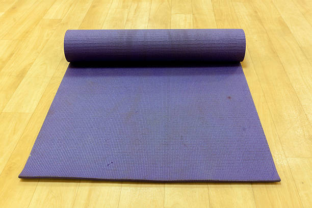 istock Yoga mat on wood background. 495921280
