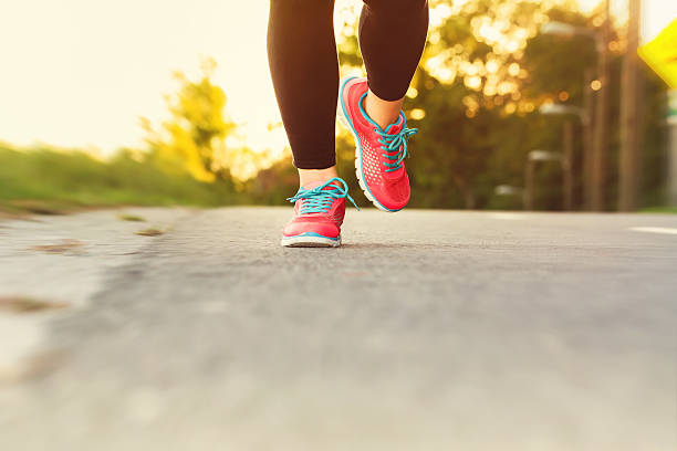istock Woman runner jogging down an outdoor path 495922268