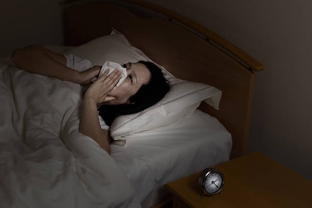 istock Mature woman sick while lying in bed at night time 495923264