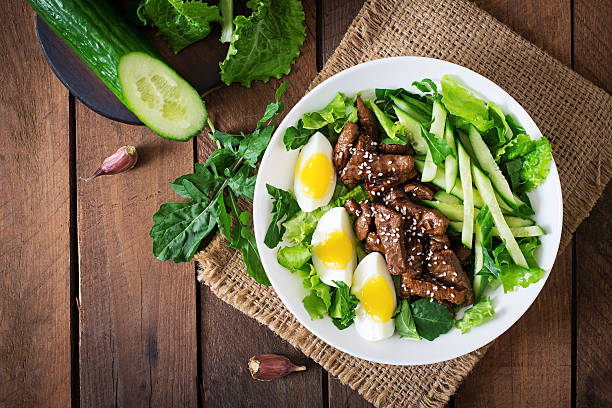 Salad with spicy beef, cucumber and eggs Salad with spicy beef, cucumber and eggs in the Asian style. Top view steak salad stock pictures, royalty-free photos & images