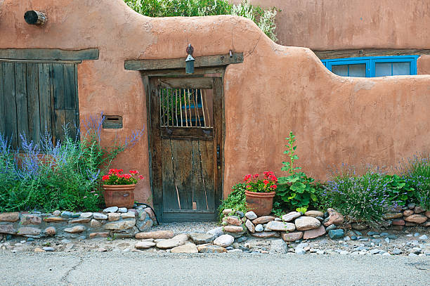 istock Santa Fe Stucco Wall, Wooden Gate and Flowers 495925566