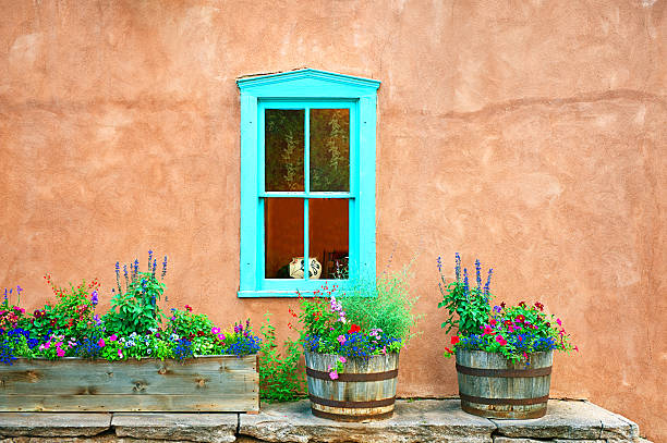 istock Santa Fe Blue Window on Stucco Wall with Flowers 495925646