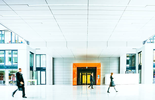 istock Blurred Businesspeople walking inside a modern building 495925818