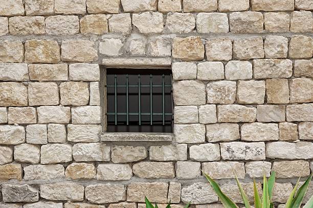 istock Old White Stonewall With Lattice Window Detail Background 495926416