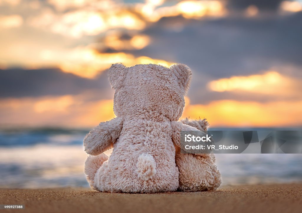Friendship - two teddy bears holding in one's arms. Safety Stock Photo