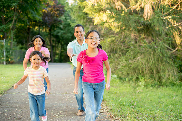 istock Family Running Through the Park 495929454