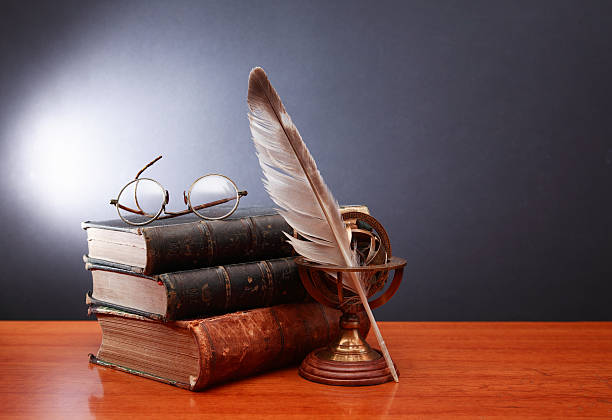Literature Concept Vintage still life with quill pen near book and spectacles on dark background poetry literature photos stock pictures, royalty-free photos & images
