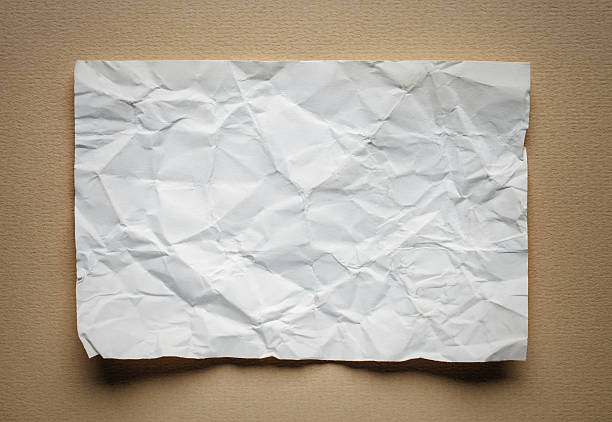 istock Crumpled  white paper card on beige background, place for text 495934270