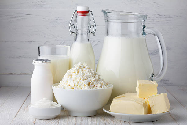 Dairy products Dairy products on white wooden table dairy stock pictures, royalty-free photos & images