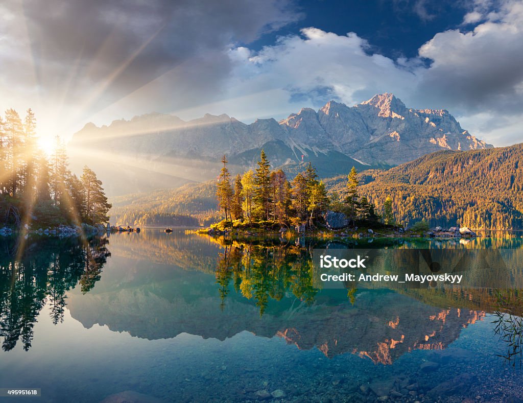 Misty summer morning on the Eibsee lake in German Alps. Misty summer morning on the Eibsee lake in German Alps. Germany, Europe. Mountain Stock Photo