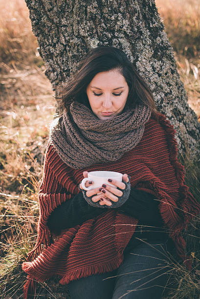 istock Woman in nature holding cup 495954860