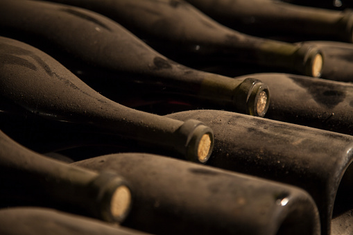 Bottles of wine aging in a cave.