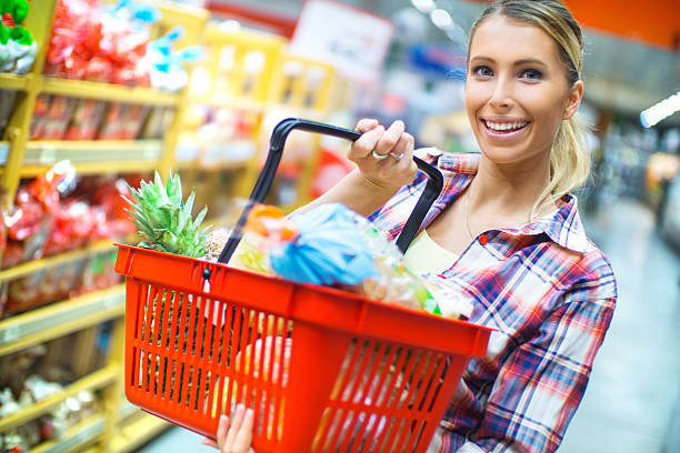 istock Woman doing grocery shooping in supermarket. 495956884