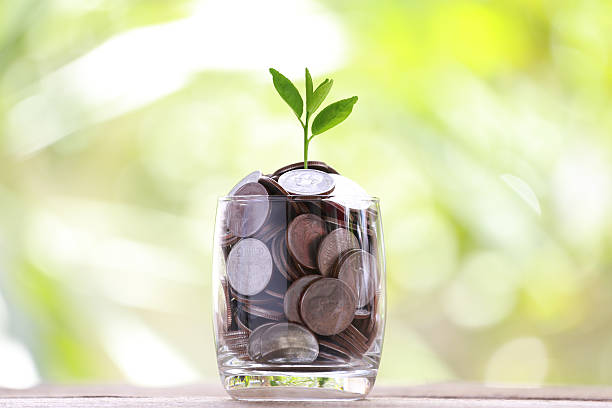 istock silver coin in glass is placed on a wood floor. 495960062