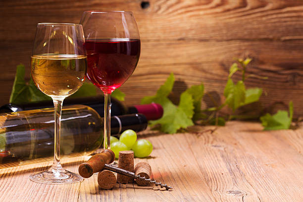 istock Glasses of red and white wine, served with grapes 495963862