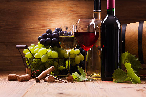 istock Glasses of red and white wine, served with grapes 495975918