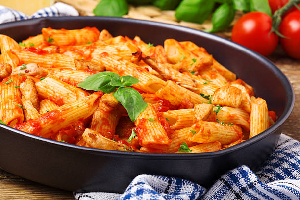 istock Penne with roasted chicken in tomato sauce 495976476