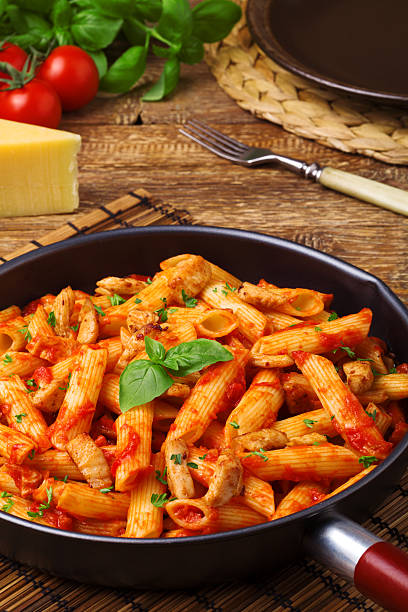 istock Penne with roasted chicken in tomato sauce 495976572