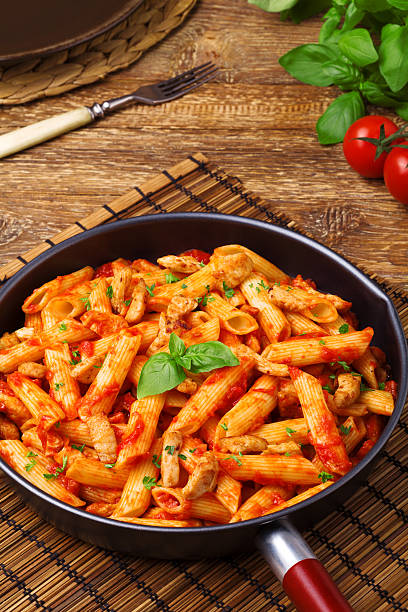 istock Penne with roasted chicken in tomato sauce 495976608