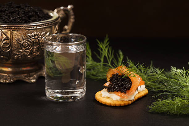 istock Black caviar served on crackers with vodka and additives 495976976